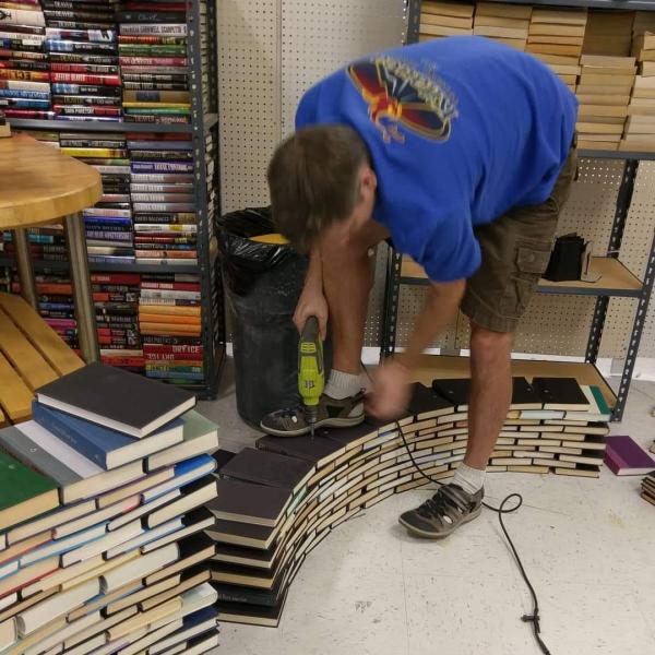 Building an Archway out of Recycled Books Construction Recycling Reusable Sustainable Green Earth Bookstore Artwork Paper Art Local Tourism 