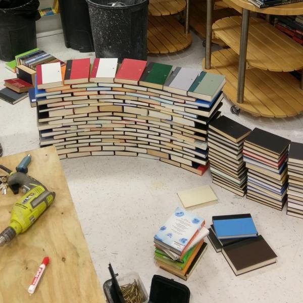 Books stacked, to be used in construction of the book arch.  Book Arch in Sandman Books Punta Gorda Florida. Florida Tourism Tourist Local Art Artist Artwork Fantasy Harry Potter Beauty and the Beast Disney Wedding Photography Unconventional Unique Venue Sell Used New Books Bookstore Bookshop Library  