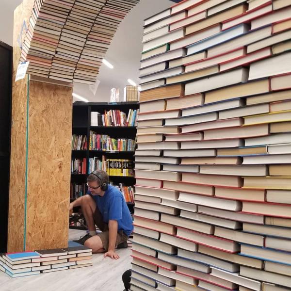 Scott Hill re-constructs the book arch in our new location.  Book Arch in Sandman Books Punta Gorda Florida. Florida Tourism Tourist Local Art Artist Artwork Fantasy Harry Potter Beauty and the Beast Disney Wedding Photography Unconventional Unique Venue Sell Used New Books Bookstore Bookshop Library  