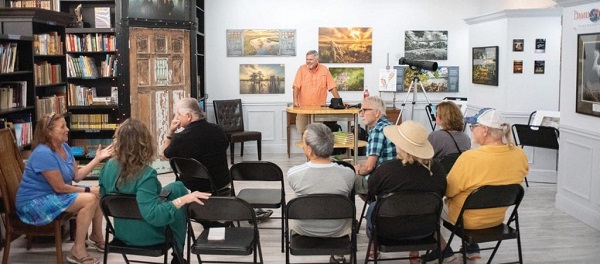 Mary Ann Tipton, David Sussman’s wife and business manager, chats with attendees before December’s PhotoTalk gets underway. Local Photography Photographer Artwork Artist Bookstore Sell Used New Books Library Punta Gorda Florida