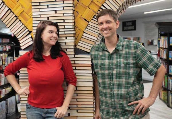 Heidi Lange and Scott Hill, owners of Sandman Books, stand in front of the Book Arch and smile. Punta Gorda Florida Tourism Tourist Local Art Artist Artwork Fantasy Harry Potter Beauty and the Beast Disney Wedding Photography Unconventional Unique Venue Sell Used New Books Bookstore Bookshop Library  