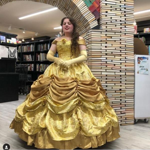 A photo of Morgan Katsarelas in Belle attire, taken by Sandman Books. Beauty and the Beast Book Arch Belle Disney Books Bookstore Book Arch Archway Art Artwork Sculpture Local Tourist Tourism Childrens Kids Library